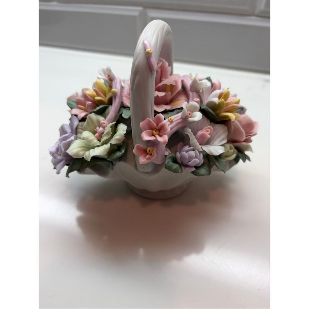Vintage Capodimonte style porcelain flower basket featuring delicate, pastel-col